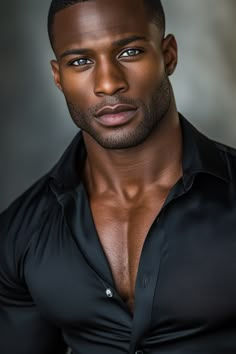 a man in black shirt looking at the camera with serious look on his face and chest