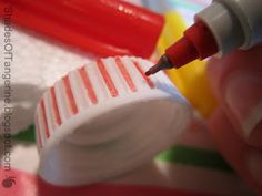 a close up of a person's hand holding a toothbrush and an empty bottle