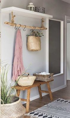 a room with some baskets and plants on the wall