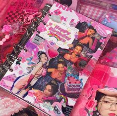 a pink scrapbook with pictures of women in the pages and on top of it