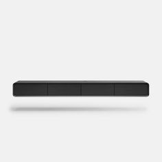 an image of a black sound bar on a white background in the style of minimalism