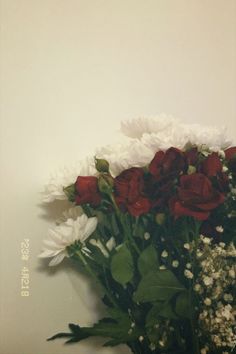 a bouquet of white and red flowers in a vase