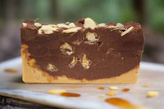 a close up of a bar of soap with nuts on the top and chocolate in the middle