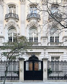 a large white building with an iron gate