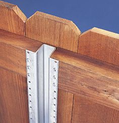 a close up of a wooden door with metal bars on the front and side panels