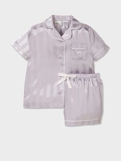 Silver sleek and satin, this silky short PJ set for girls is perfect for the princess at home who adores the finer things. With a matching box, this set makes the perfect gift for any little girl in your life! * Collar & button down front * Top Patch pocket * Short sleeves * Matching PJ short * Elasticated waistband with drawstring * Comes in matching bag * This style features our iconic Peter Alexander Penny logo * Matching style for women Peter Alexandra Pjs, Pajamas Silk, Girls Pjs