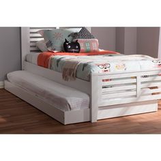 a cat is sitting on top of a bed with white slatted headboard