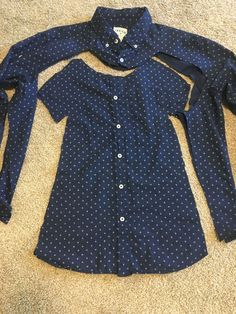 a blue shirt with white polka dots on it