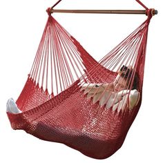 a woman laying in a red hammock