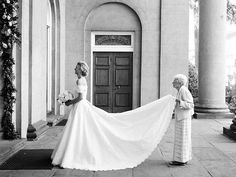 a woman in a wedding dress standing next to another woman