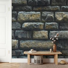 a room with a table, vase and brick wallpaper