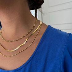 Triple Layered Stainless Steel Gold Necklace - Rope, Flat Snake & Wavy Chain Set - Dainty Minimalist Gold Cover Jewelry for Women, Perfect for Layering & Casual Chic Style The necklace in the image appears to be a layered stainless steel gold chain necklace with three distinct styles: 1.First Layer (Top Layer): A fine, twisted rope chain, adding a delicate, textured look. 2.Second Layer (Middle Layer): A sleek, slightly curved flat chain that sits close to the neck, adding elegance with a smooth, reflective surface. 3.Third Layer (Bottom Layer): Another flat snake chain with a slightly wavy shape, giving the set an eye-catching and modern touch. Made of 316L Stainless Steel Bracelet gold plated gold Color adjustable + 5mm The best piece for your wardrobe. Designed for the Long Term. --- SH Flat Snake Chain, Luxury Jewelry Box, Layered Chain Necklace, Layered Chain, Layered Necklace Set, Multi Layer Necklace, Gold Necklace Layered, Casual Chic Style, Gold Chain Necklace