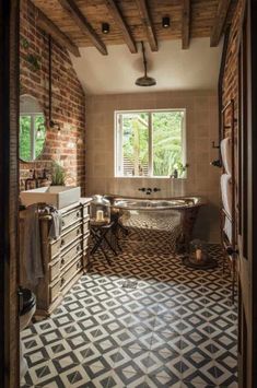 an open door leading to a bathroom with a large tub and sink in the center