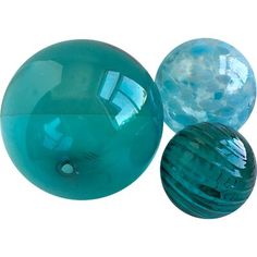 three glass balls sitting next to each other