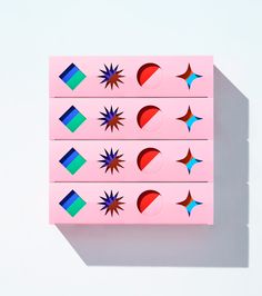 three pink boxes with different shapes on them