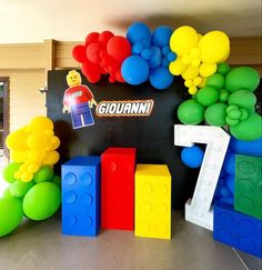 balloons and legos decorate the entrance to a birthday party