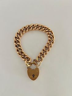 Antique Victorian Gold Heart Lock Curbchain Bracelet - 15k. During the Victorian Era, the heart lock bracelet was a symbol of love and fidelity. The heart lock is simple and classic, made of solid 15k gold. MARKINGS AND HISTORY: Marked 15k gold, with British hallmarks as shown in photo. (Please reach out if more information is needed!) ERA: Circa 1880's OVERALL CONDITION: This beautiful bracelet is in excellent condition overall, all links are in great condition and the heart lock is functioning perfectly. The bracelet also has a safety chain, adding extra security. There are some small surface scratches on the lock. Timeless Gold Curb Chain Bracelet As Gift, Timeless Gold Curb Chain Bracelet For Gift, Timeless Gold Bracelet With Curb Chain For Gift, Classic Formal Bracelet With Heart Charm, Classic Gold Lock Jewelry, Classic Bracelets With Heart Charm, Classic Gold Jewelry With Lock Detail, Classic Yellow Gold Heart Charm Bracelet, Classic Gold Heart Bracelet With Charm