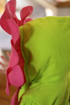 a green and pink dress with ruffles on it