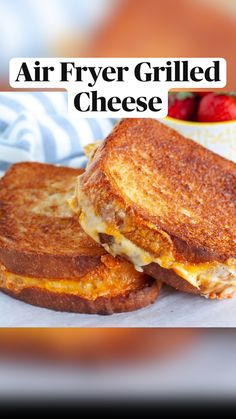 two grilled cheese sandwiches sitting on top of a white plate next to strawberries