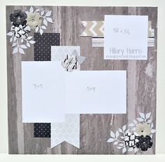 some paper flowers and white tags on a wooden board