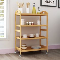 a wooden shelf with dishes and cups on it