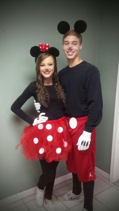 a man and woman in mickey mouse costumes