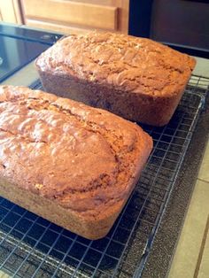 two loafs of bread sitting on top of a cooling rack