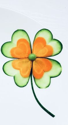 a four leaf clover on a plate with green and orange highlights in the center,