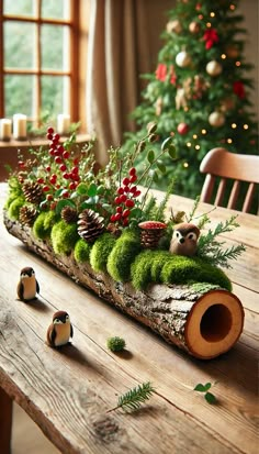 a wooden table topped with lots of green plants and pineconi in front of a christmas tree