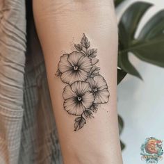 a black and white flower tattoo on the arm