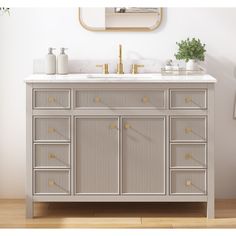 an image of a bathroom vanity with drawers and mirrors on the wall in front of it