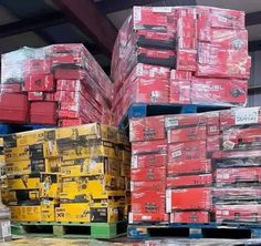 stacks of red and yellow boxes stacked on top of each other in a storage room