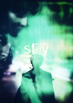 a blurry image of two people standing in front of a green background with the words stay on it