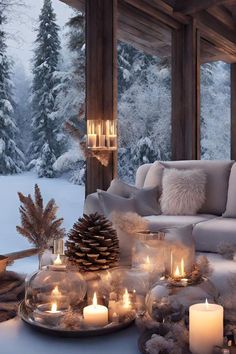 a living room filled with lots of furniture and lit candles in front of a window