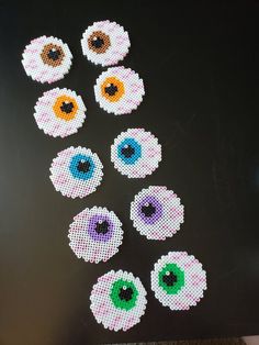 the cross - stitch eyeballs are arranged on top of each other in different colors