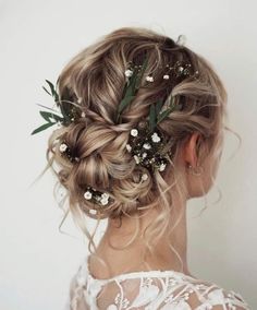 a woman with blonde hair and flowers in her hair