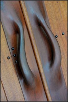 two wooden handles on the back of a chair with nail polishing applied to them