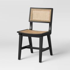 a black chair with wicker back and seat