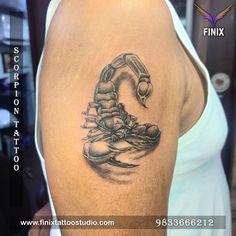 a black and white photo of a man's arm with a scorpion tattoo on it