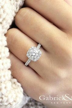 a woman's hand with a diamond ring on it