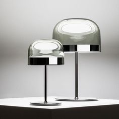 two lamps sitting on top of a white table