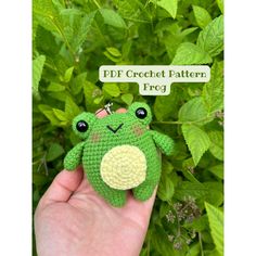 a small crocheted frog sitting on top of a green leafy plant with the caption pdf crochet pattern frog