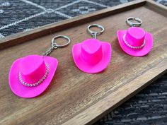 Mini pink cowgirl hat keychains! Perfect for bachelorette gifts, birthdays, girlfriends, etc. Lightweight and super durable. Available with or without rhinestones. ~About 4" from bottom of hat to key ring  ~Bright pink ~Optional rhinestones ~Limit 2 per order (unless for a bachelorette multiple person gift) ~Silver key ring only Pink Cowgirl Hat, Pink Cowgirl Boots, Pink Cowgirl, Mini Pink, Silver Key, Cowgirl Hat, Bachelorette Gifts, Cowgirl Hats, Pink Mini