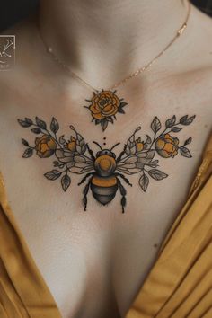 a woman's chest with a bee and flowers on it