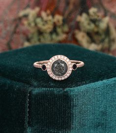 a diamond ring sitting on top of a velvet box