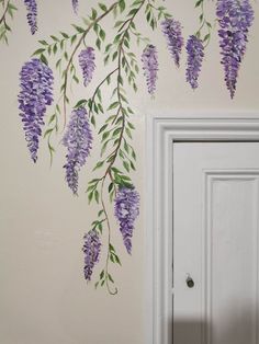 purple flowers painted on the wall next to a white door