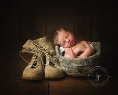 a newborn baby is curled up in a basket with his head resting on the shoelaces