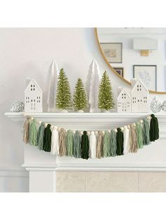 a mantle with christmas decorations and trees on it