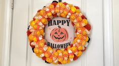 a happy halloween wreath with candy on it