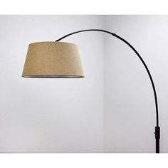 a lamp that is next to a wall with a light on it and a floor lamp